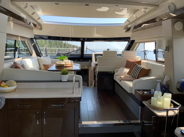  Yacht Photos Pics Luxurious interior of 2018 Carver C52 Coupe yacht with elegant seating and panoramic windows.
