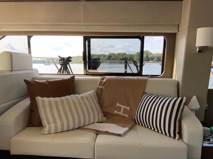  Yacht Photos Pics Luxurious interior of 2018 Carver C52 Coupe yacht with plush cushions and scenic window view.