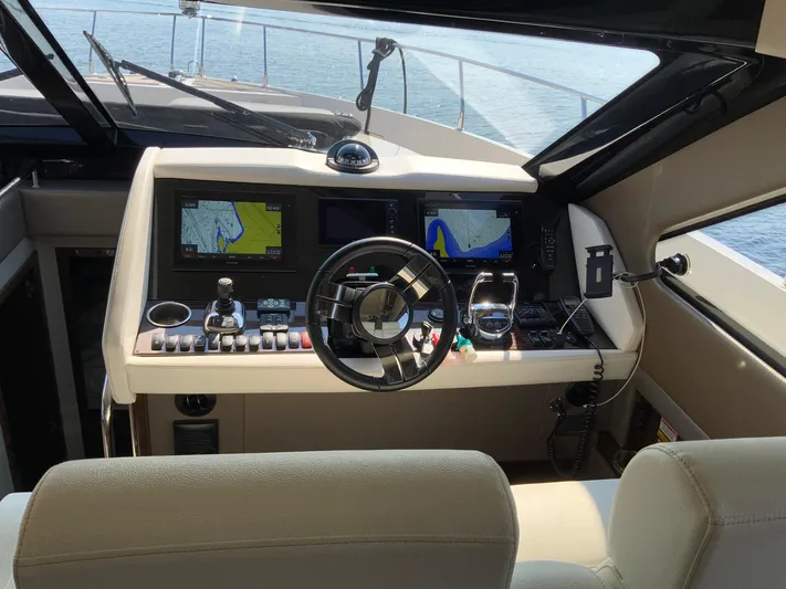  Yacht Photos Pics Interior helm of 2018 Carver C52 Coupe with navigation screens and steering wheel.