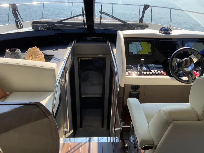  Yacht Photos Pics Interior of 2018 Carver C52 Coupe yacht with navigation controls and seating.