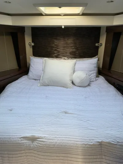 Yacht Photos Pics Luxurious bedroom interior of 2018 Carver C52 Coupe yacht with elegant bedding.
