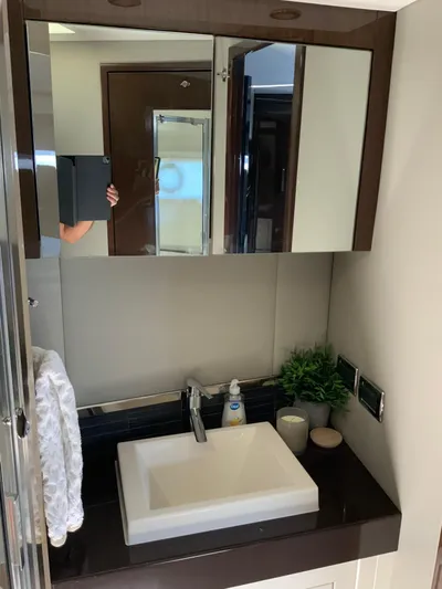  Yacht Photos Pics Modern bathroom vanity in 2018 Carver C52 Coupe yacht, featuring sleek sink and mirrored cabinet.