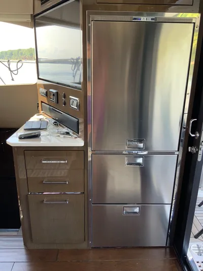  Yacht Photos Pics Modern kitchen area in a 2018 Carver C52 Coupe yacht with stainless steel appliances.