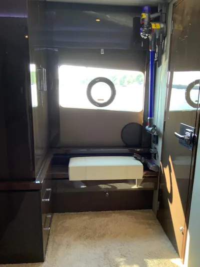  Yacht Photos Pics Interior of a 2018 Carver C52 Coupe yacht with a window and seating area.