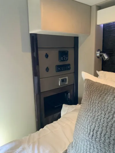  Yacht Photos Pics Interior of 2018 Carver C52 Coupe yacht, featuring a control panel and plush bedding.