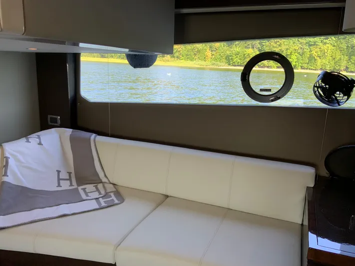  Yacht Photos Pics Interior of 2018 Carver C52 Coupe yacht with white sofa and scenic water view.