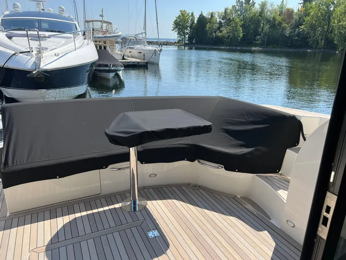  Yacht Photos Pics 2018 Carver C52 Coupe yacht with covered seating area, docked at a marina.