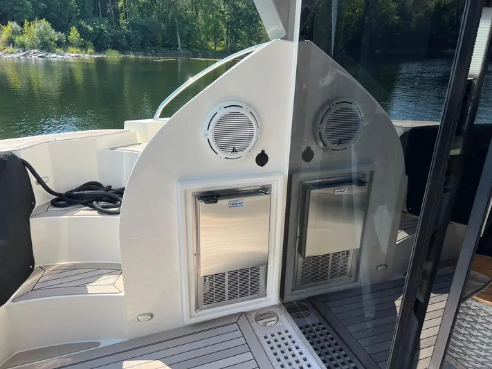  Yacht Photos Pics 2018 Carver C52 Coupe yacht deck with storage compartments and scenic water view.