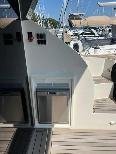  Yacht Photos Pics 2018 Carver C52 Coupe yacht deck with modern amenities and marina background.