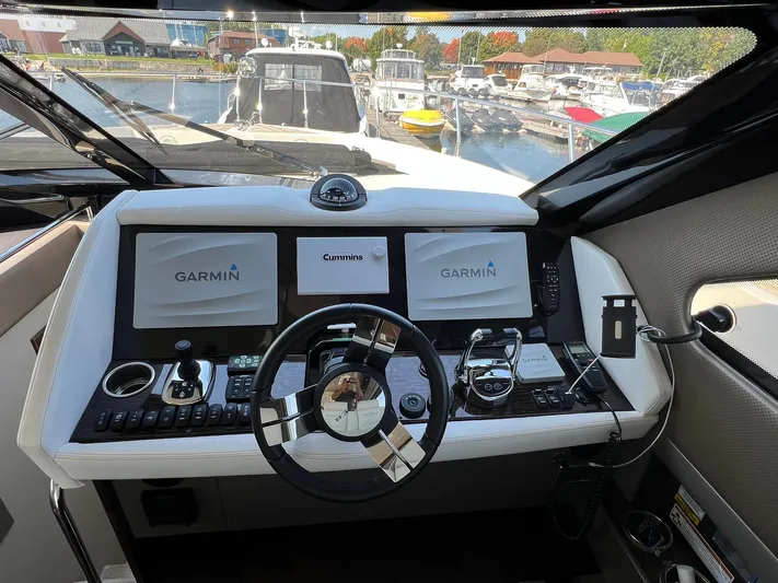  Yacht Photos Pics Helm of 2018 Carver C52 Coupe with Garmin navigation displays at marina.