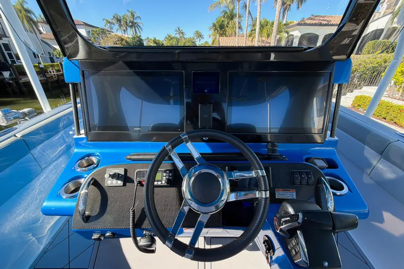  Yacht Photos Pics 2023 Mystic Powerboats M3800 helm with dual screens and sleek steering wheel.