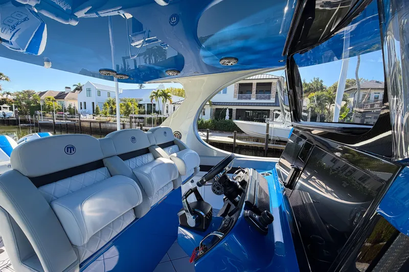  Yacht Photos Pics Interior of 2023 Mystic Powerboats M3800, featuring luxurious seating and modern dashboard.