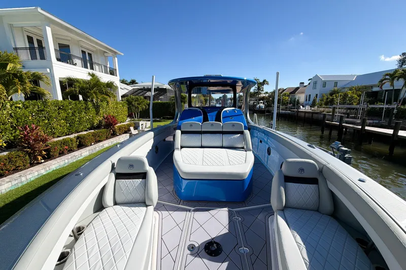  Yacht Photos Pics 2023 Mystic Powerboats M3800 luxury boat docked by waterfront homes.
