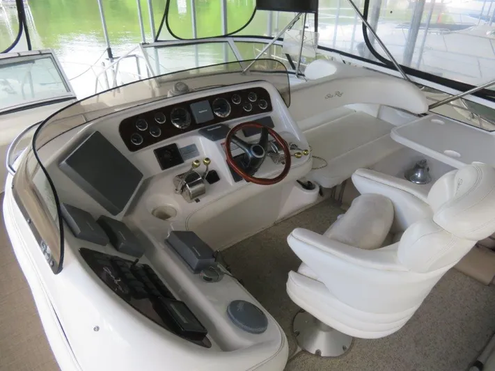  Yacht Photos Pics 2002 Sea Ray 450 Express Bridge helm station with captain's chair and control panel.