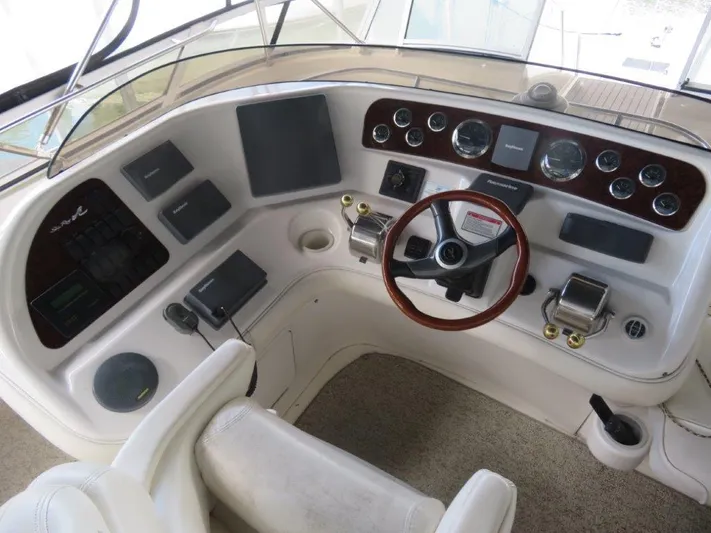 Yacht Photos Pics Cockpit of a 2002 Sea Ray 450 Express Bridge yacht with steering wheel and control panel.