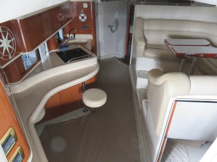  Yacht Photos Pics Interior of 2002 Sea Ray 450 Express Bridge yacht with kitchen and seating area.