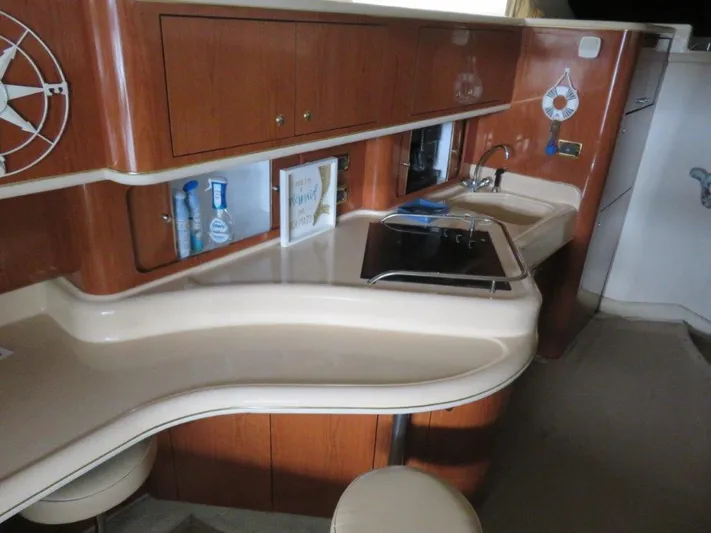  Yacht Photos Pics 2002 Sea Ray 450 Express Bridge kitchen with wooden cabinets and modern amenities.