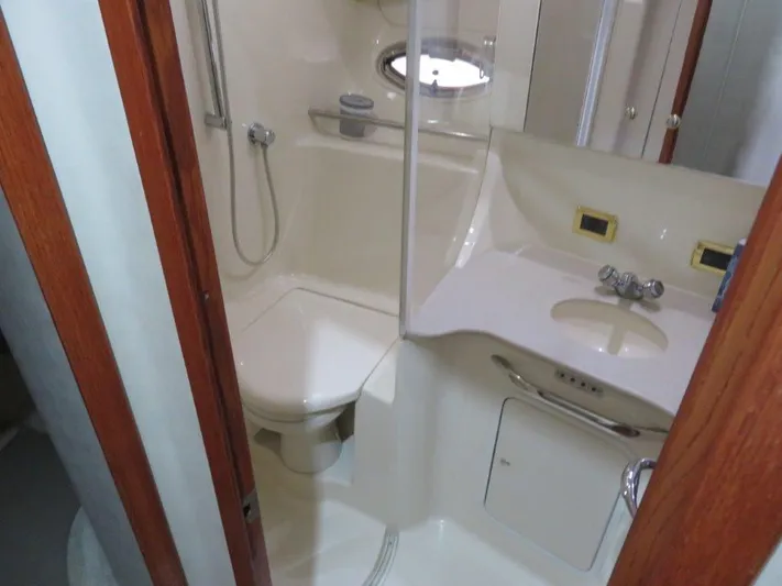  Yacht Photos Pics Bathroom of 2002 Sea Ray 450 Express Bridge yacht with shower, toilet, and sink.