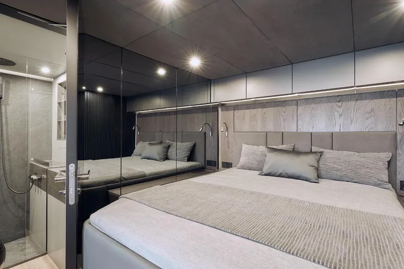  Yacht Photos Pics Luxurious bedroom interior of 2026 Sunreef 60 Power yacht with modern design and elegant bedding.