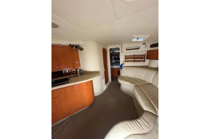Knot Squared II Yacht Photos Pics Interior of 1999 Sea Ray 400 Sundancer yacht with leather seating and wooden cabinetry.