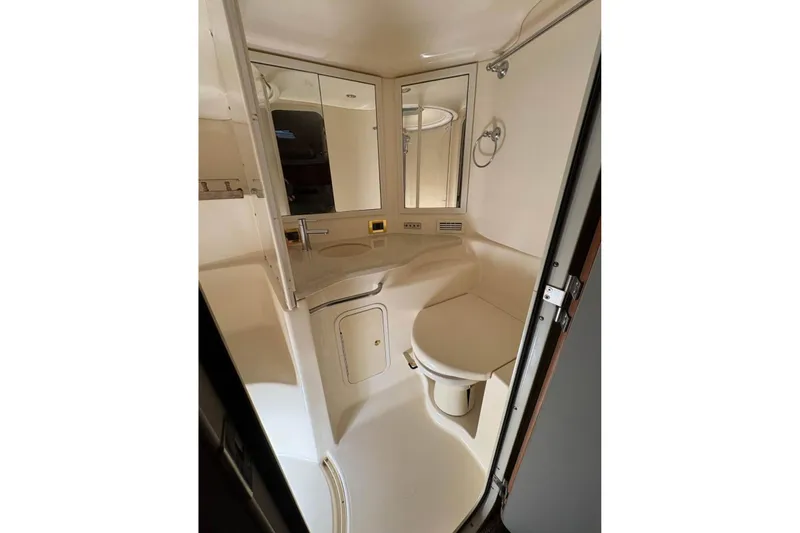 Knot Squared II Yacht Photos Pics Bathroom interior of 1999 Sea Ray 400 Sundancer yacht, featuring sink and mirror.