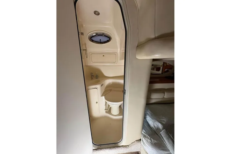 Knot Squared II Yacht Photos Pics 1999 Sea Ray 400 Sundancer bathroom interior with compact design and porthole window.