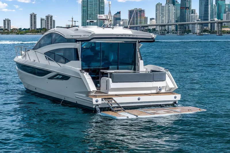  Yacht Photos Pics 2018 Galeon 430 HTC yacht on water with city skyline in background.