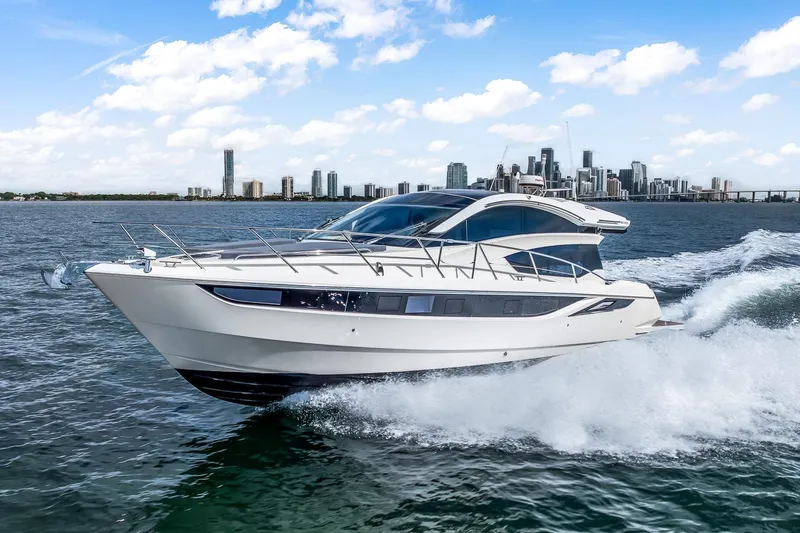  Yacht Photos Pics 2018 Galeon 430 HTC yacht cruising near city skyline on a sunny day.