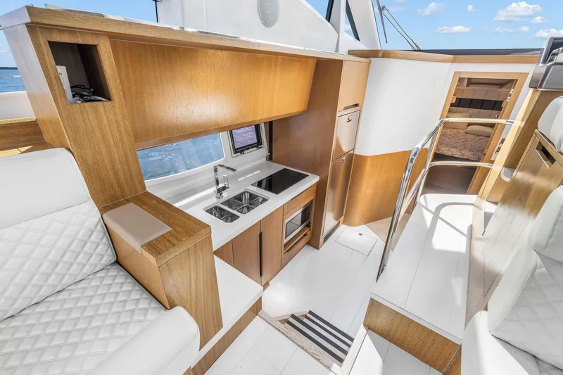 Yacht Photos Pics Luxurious interior of 2018 Galeon 430 HTC yacht with modern kitchen and seating.