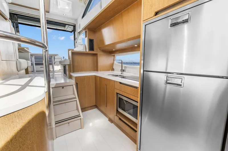  Yacht Photos Pics Modern kitchen interior of 2018 Galeon 430 HTC yacht with stainless steel appliances.