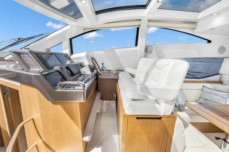  Yacht Photos Pics Luxurious interior of 2018 Galeon 430 HTC yacht with modern helm and seating.