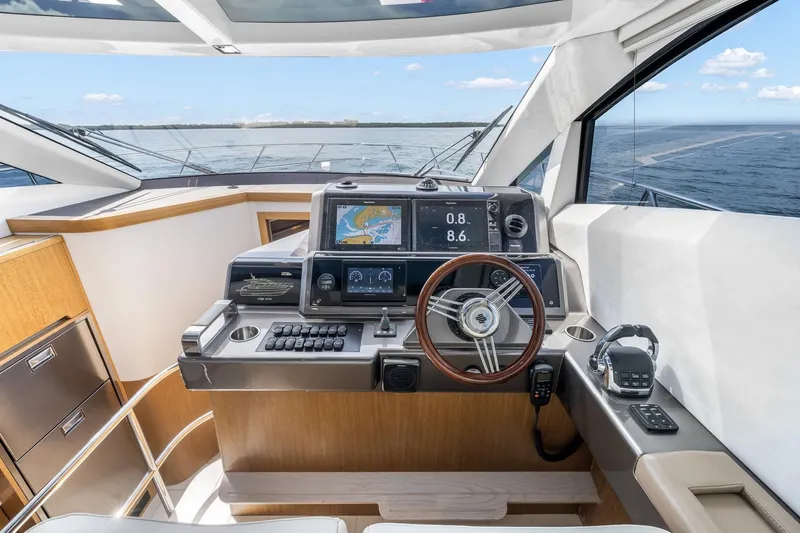  Yacht Photos Pics 2018 Galeon 430 HTC yacht helm with navigation screens and steering wheel, overlooking the ocean.