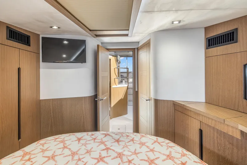  Yacht Photos Pics Luxurious interior of 2018 Galeon 430 HTC yacht with modern wood finishes and TV.