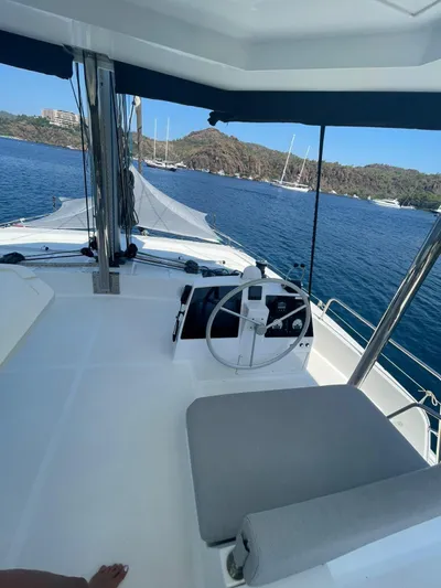  Yacht Photos Pics Bali 4.8 catamaran helm, 2021 model, with scenic ocean view and distant sailboats.