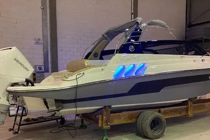  Yacht Photos Pics 2024 Hanover 305 White & Gray Edition boat in a garage with blue accent lights.