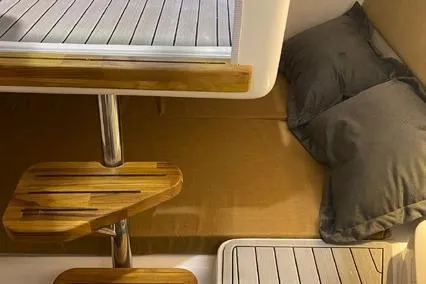  Yacht Photos Pics 2024 Hanover 305 White & Gray Edition interior with wooden steps and cozy bedding.