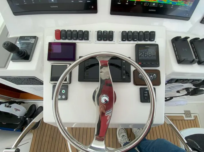 Salty Bear Yacht Photos Pics Control panel of 2022 Albemarle 360 Express Fisherman with steering wheel and navigation instruments.