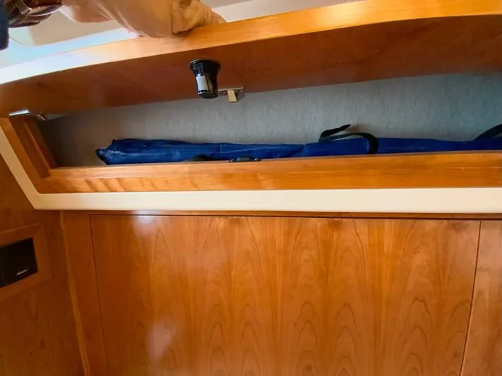 Salty Bear Yacht Photos Pics 2022 Albemarle 360 Express Fisherman interior storage compartment with wooden finish.