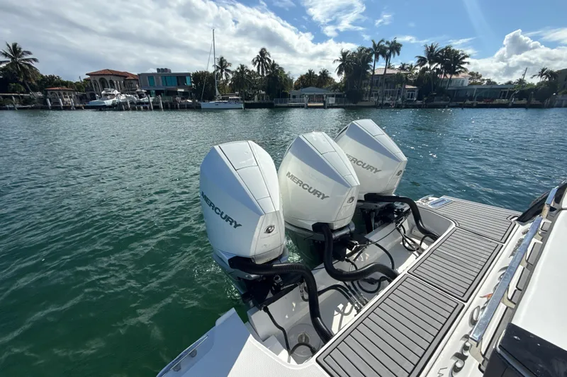  Yacht Photos Pics 2019 Monterey 385 Super Express with triple Mercury outboard engines on a sunny waterfront.