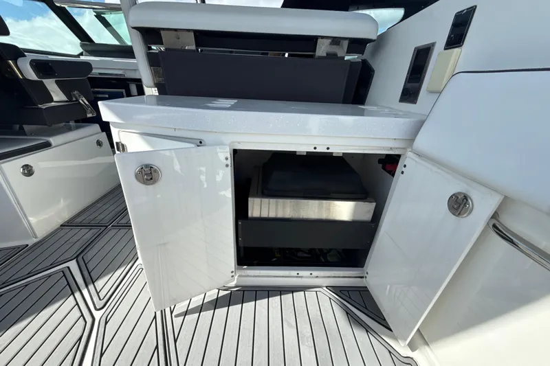  Yacht Photos Pics 2019 Monterey 385 Super Express interior with open storage compartment and sleek design.