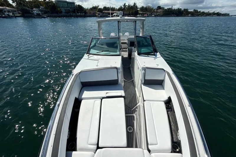  Yacht Photos Pics 2019 Monterey 385 Super Express boat on calm water, featuring spacious seating.