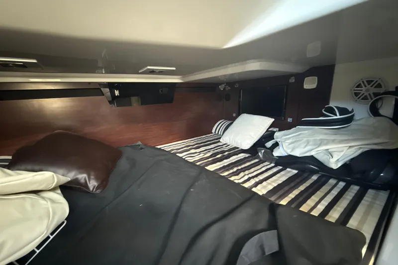 Yacht Photos Pics Interior cabin of 2019 Monterey 385 Super Express with striped bedding and pillows.