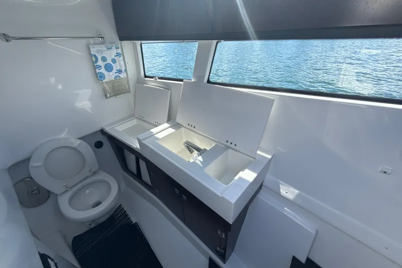  Yacht Photos Pics Bathroom interior of 2019 Monterey 385 Super Express yacht with dual sinks and toilet.