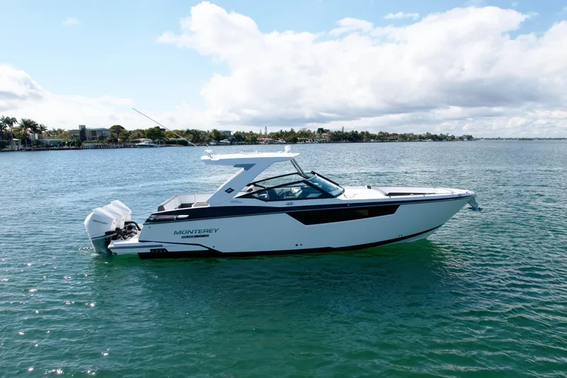  Yacht Photos Pics 2019 Monterey 385 Super Express boat on calm water under a partly cloudy sky.