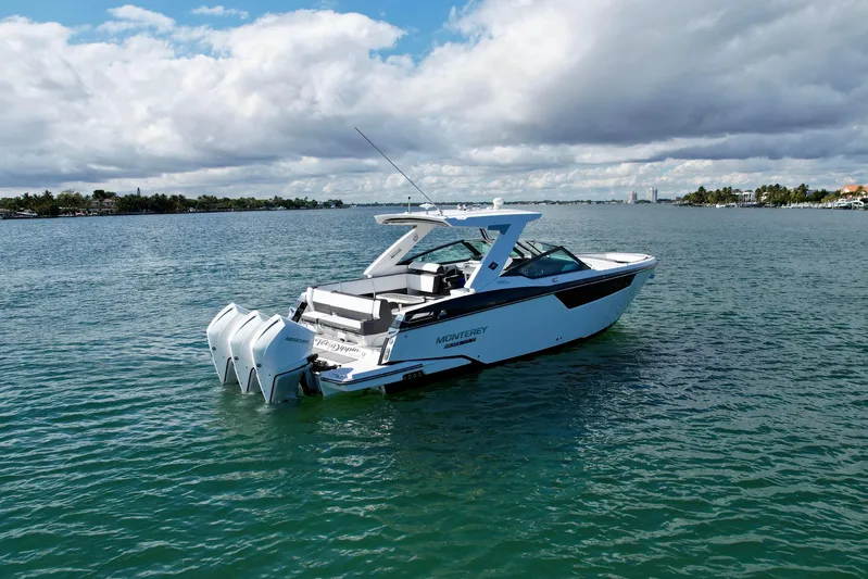  Yacht Photos Pics 2019 Monterey 385 Super Express boat on calm water under cloudy sky.
