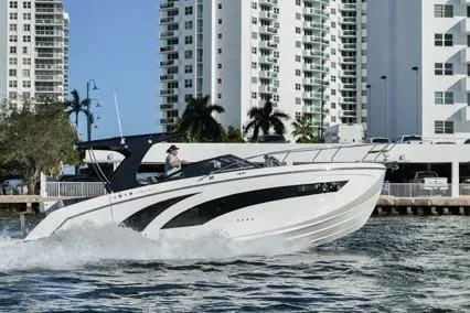  Yacht Photos Pics 2023 Hanover 377 boat cruising near modern waterfront buildings.