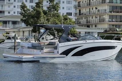  Yacht Photos Pics 2023 Hanover 377 boat cruising near waterfront buildings and trees.