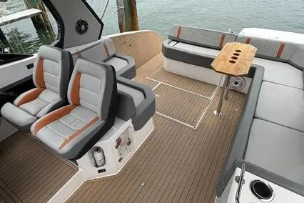  Yacht Photos Pics 2023 Hanover 377 boat interior with modern seating and wooden deck.