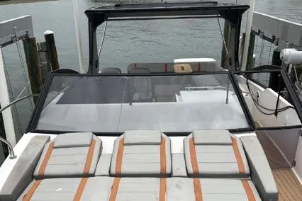  Yacht Photos Pics 2023 Hanover 377 boat with sleek design and comfortable seating at a dock.