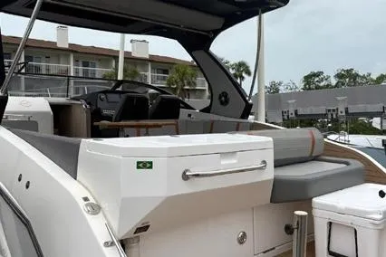  Yacht Photos Pics 2023 Hanover 377 boat with sleek design, docked near waterfront buildings.